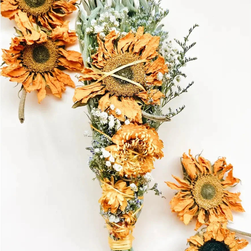 sage smudge stick with dried sunflowers and baby's breath