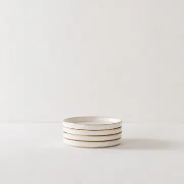 small cream colored plate with natural rim