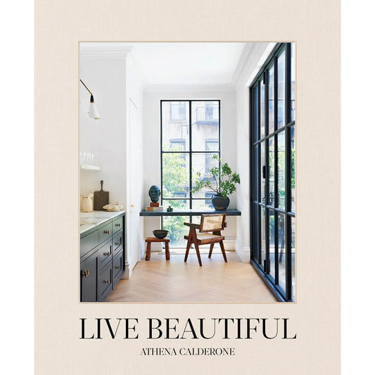 Cover of the book 'Live Beautiful' by Athena Calderone, featuring a room with stylish decor and large windows.