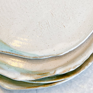 white ceramic dinner and salad plates with green glaze accents