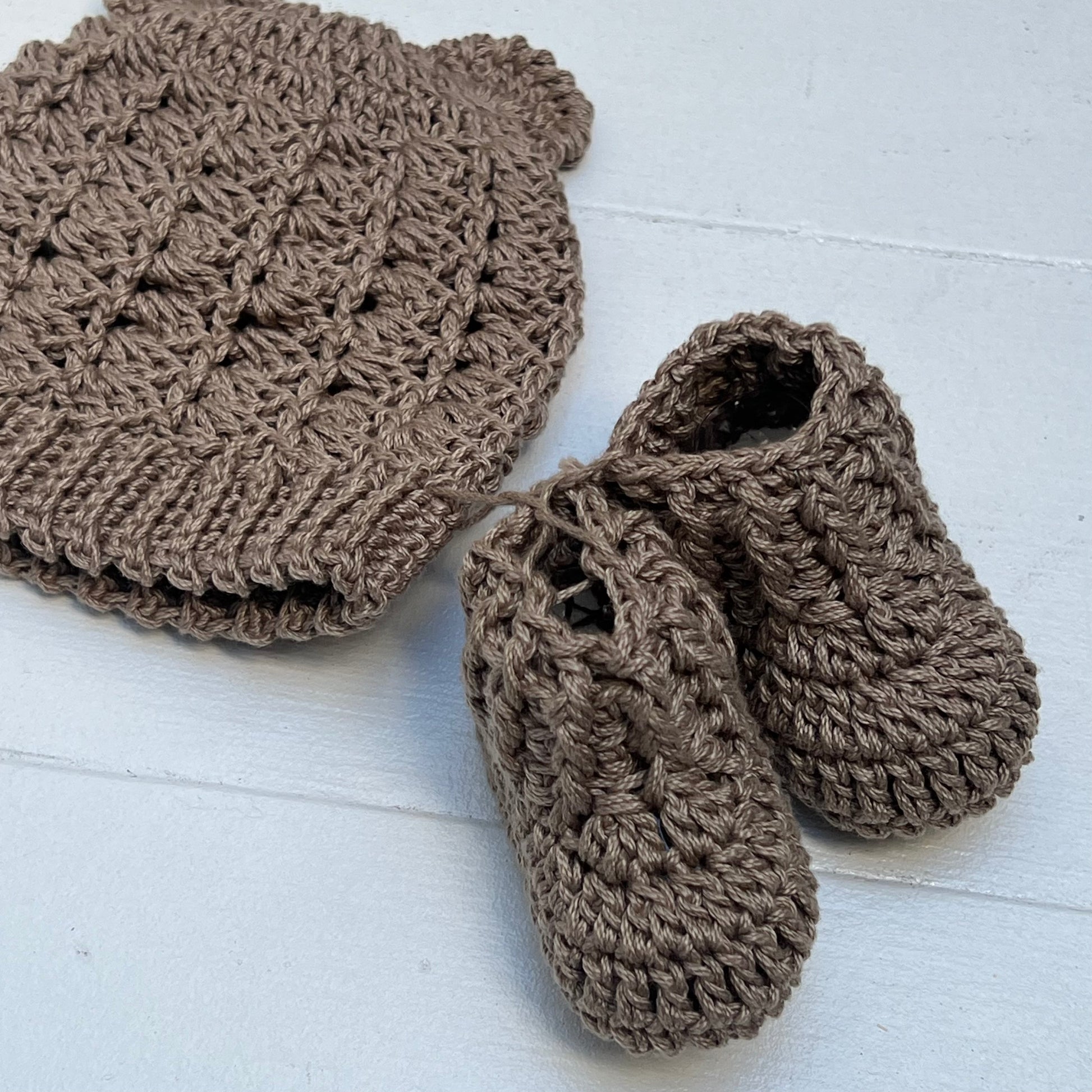 brown hand knit baby hat with small ears and booties