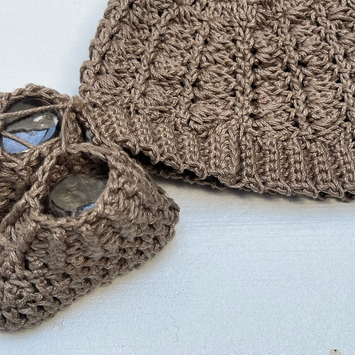 brown hand knit baby hat with small ears and booties