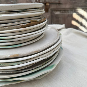 white ceramic dishes with brown speckles and green and brown glaze accents