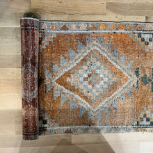 Load image into Gallery viewer, vintage runner rug with orange, rust, dark gray and off white colors with geometric pattern