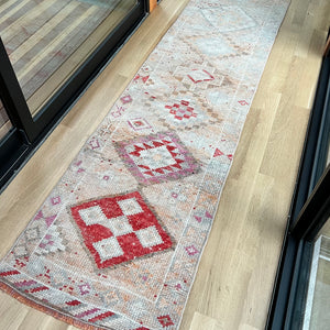vintage Turkish runner rug with red, pink, cream and off white colors