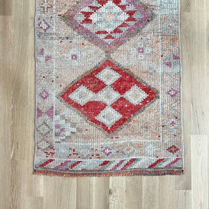 vintage Turkish runner rug with red, pink, cream and off white colors