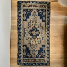 Load image into Gallery viewer, vintage area rug with navy, brown, tan and cream colored pattern