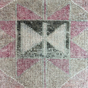 vintage runner rug with geometric pattern in faded pinks and beige