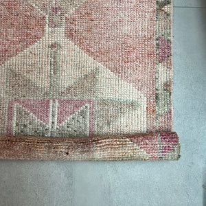 vintage runner rug with geometric pattern in faded pinks and beige