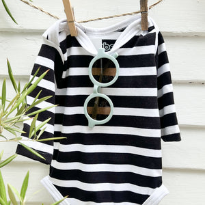 light blue toddler sunglasses hanging on a black and white striped long sleeve baby retro swimsuit