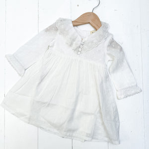 white cotton toddler dress with long sleeves and collar