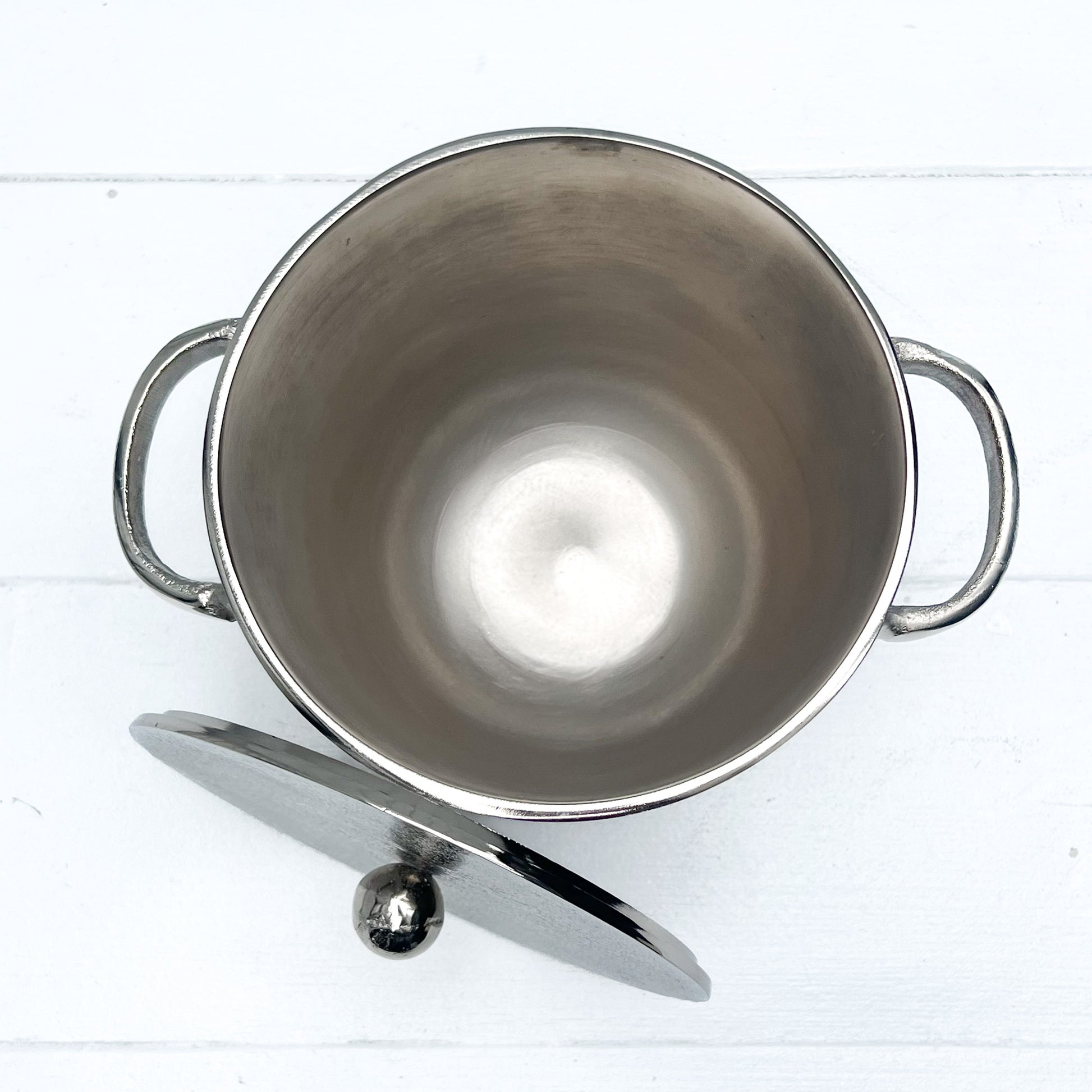silver metal ice bucket with two handles and a lid