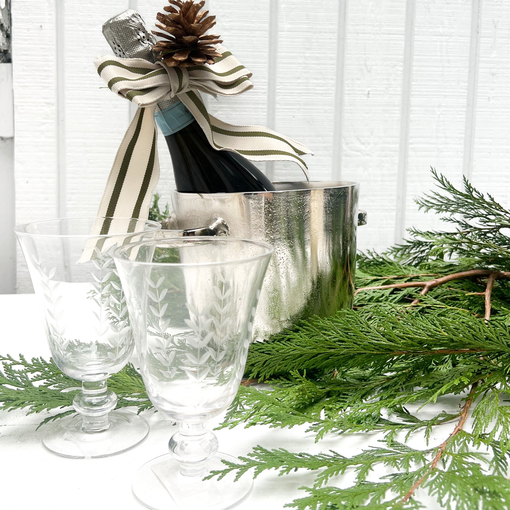 silver metal ice bucket with two handles and a lid