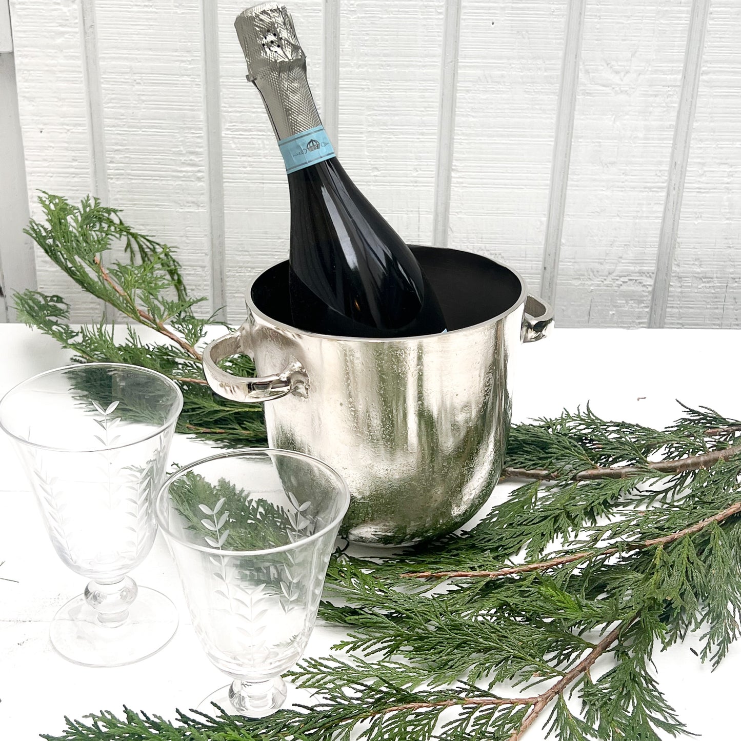 silver metal ice bucket with two handles and a lid