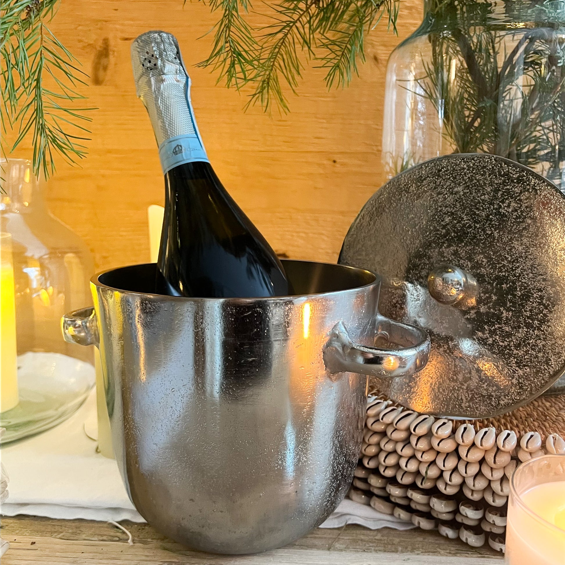 silver metal ice bucket with two handles and a lid