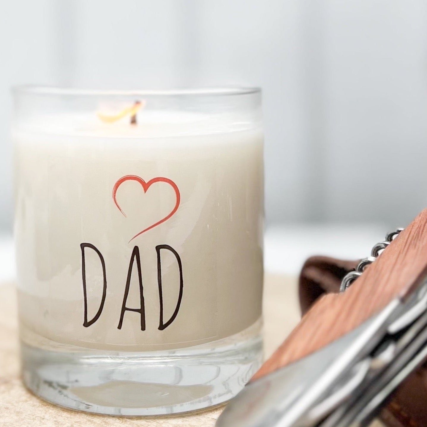 fraser fir scented candle in clear glass jar with black letters and red heart