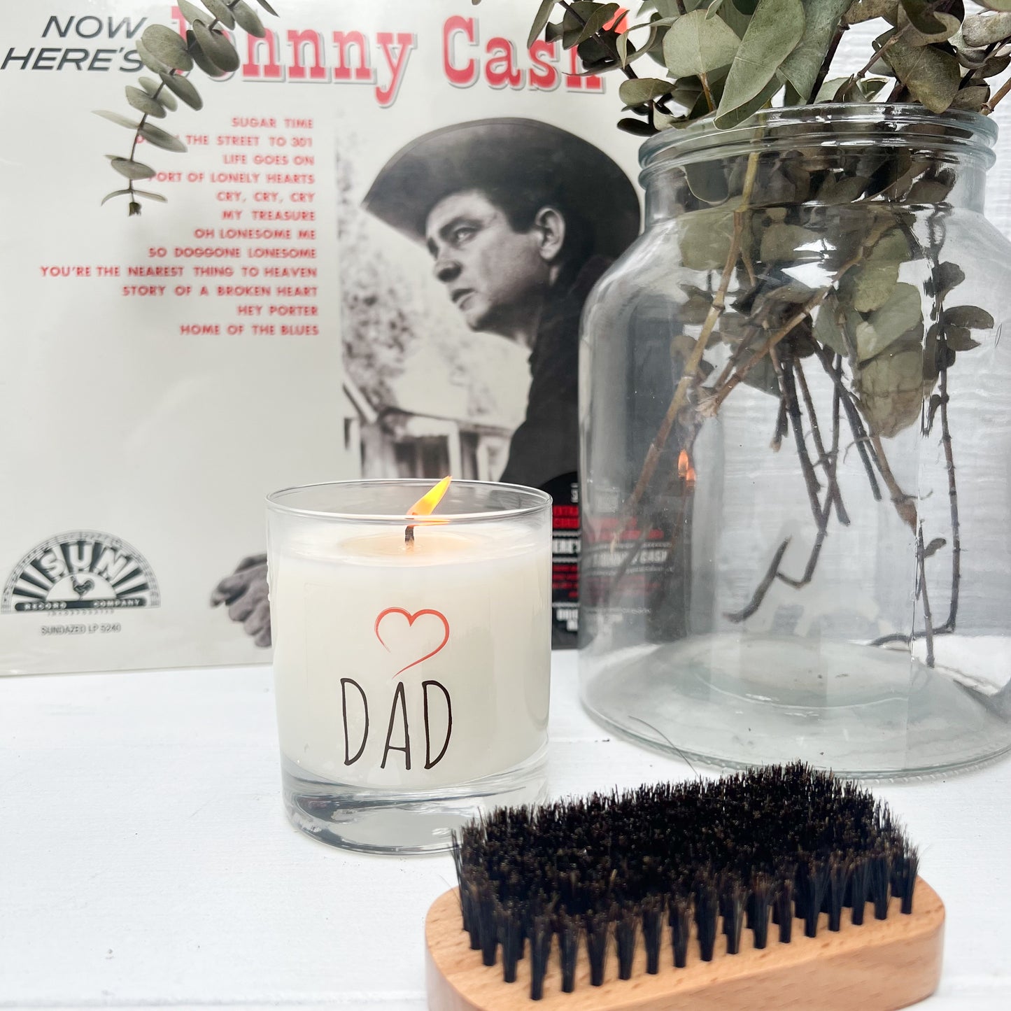 fraser fir scented candle in clear glass jar with black letters and red heart