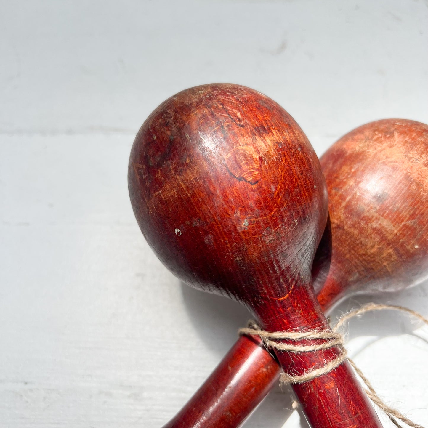 vintage wooden hand held dumbbells in cherrywood color with some aging.