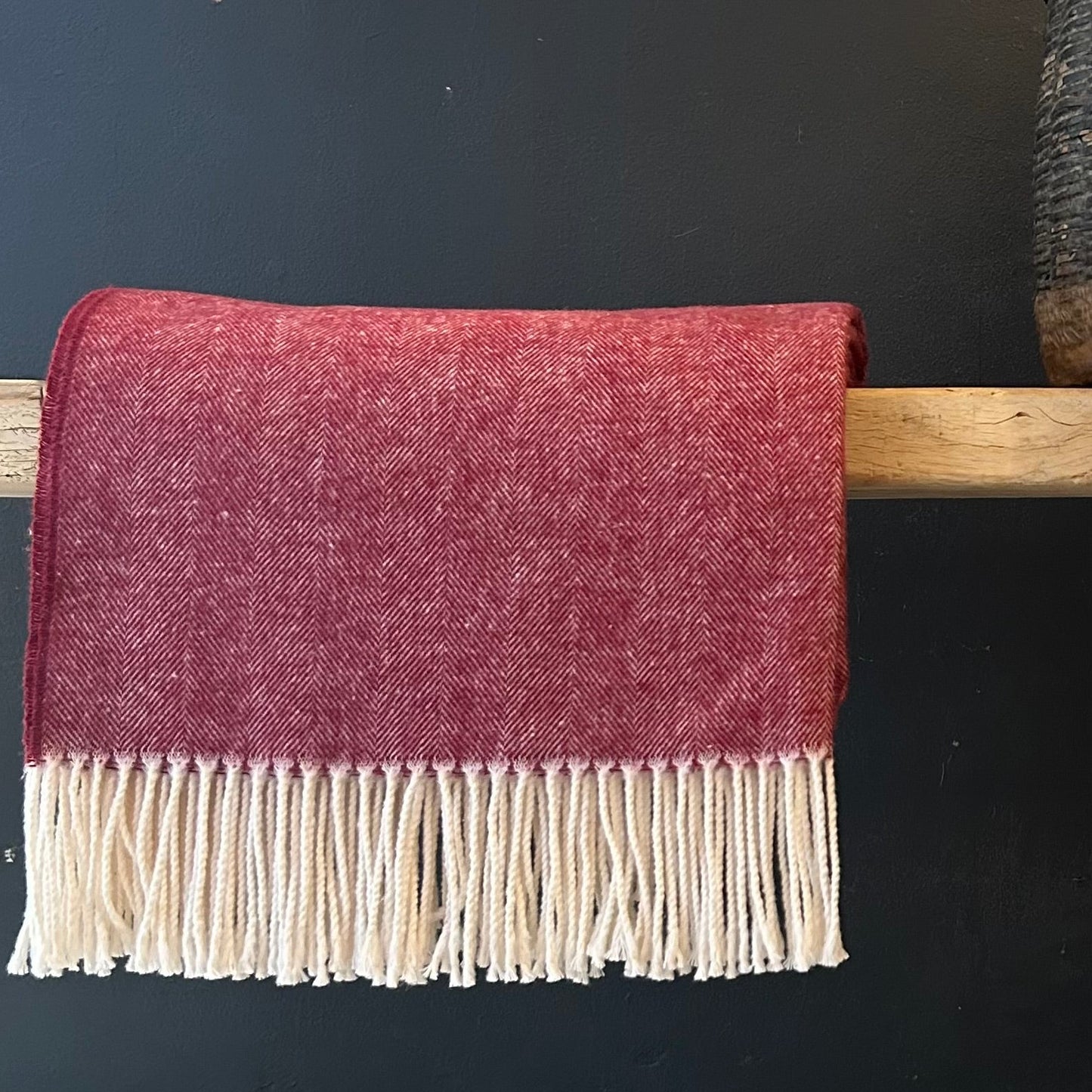cranberry colored herringbone throw with cream colored fringe