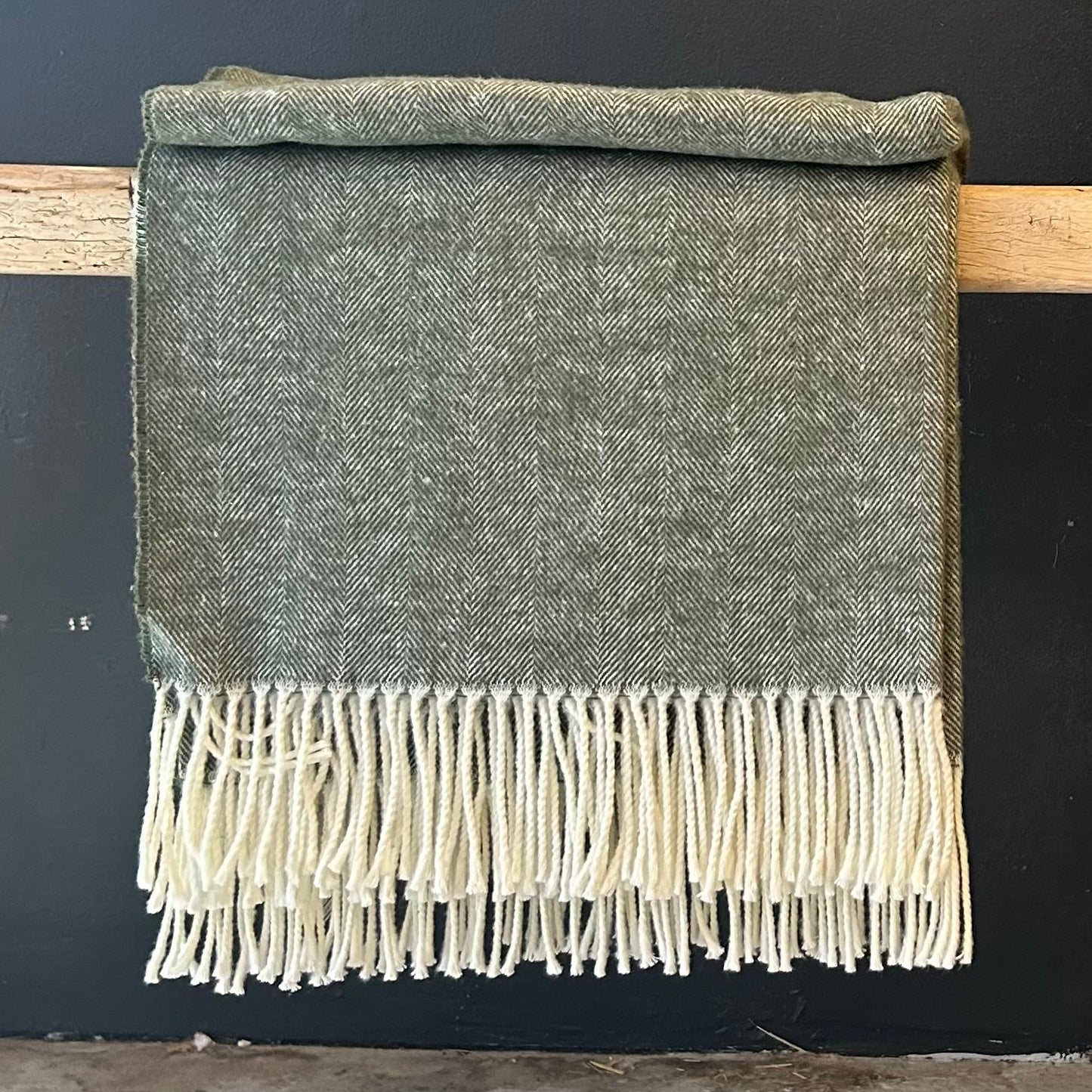 forest green herringbone throw with cream colored fringe