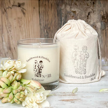 Load image into Gallery viewer, tuberose scented clear glass candle with Tumbleweed and Dandelion logo in black