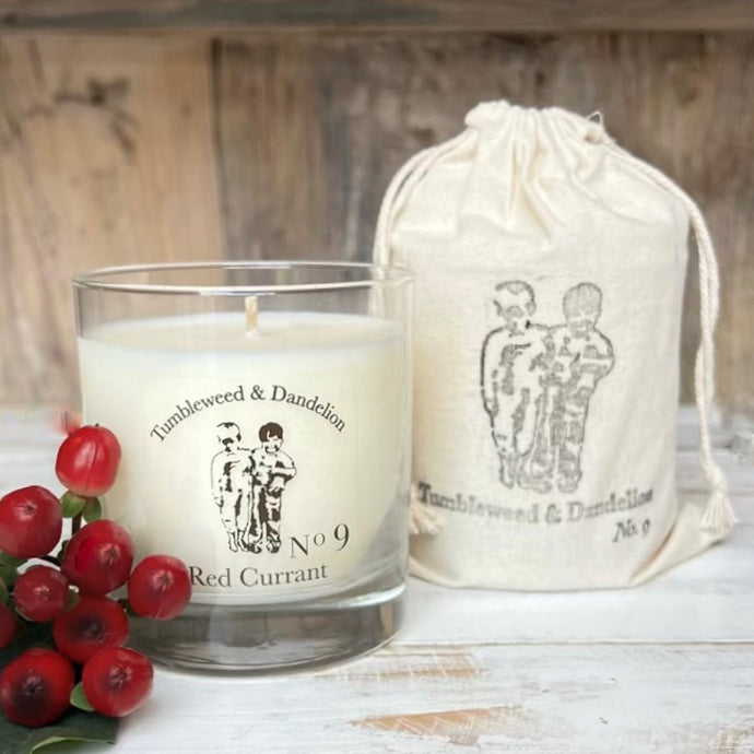 red currant scented candle in clear glass with black logo
