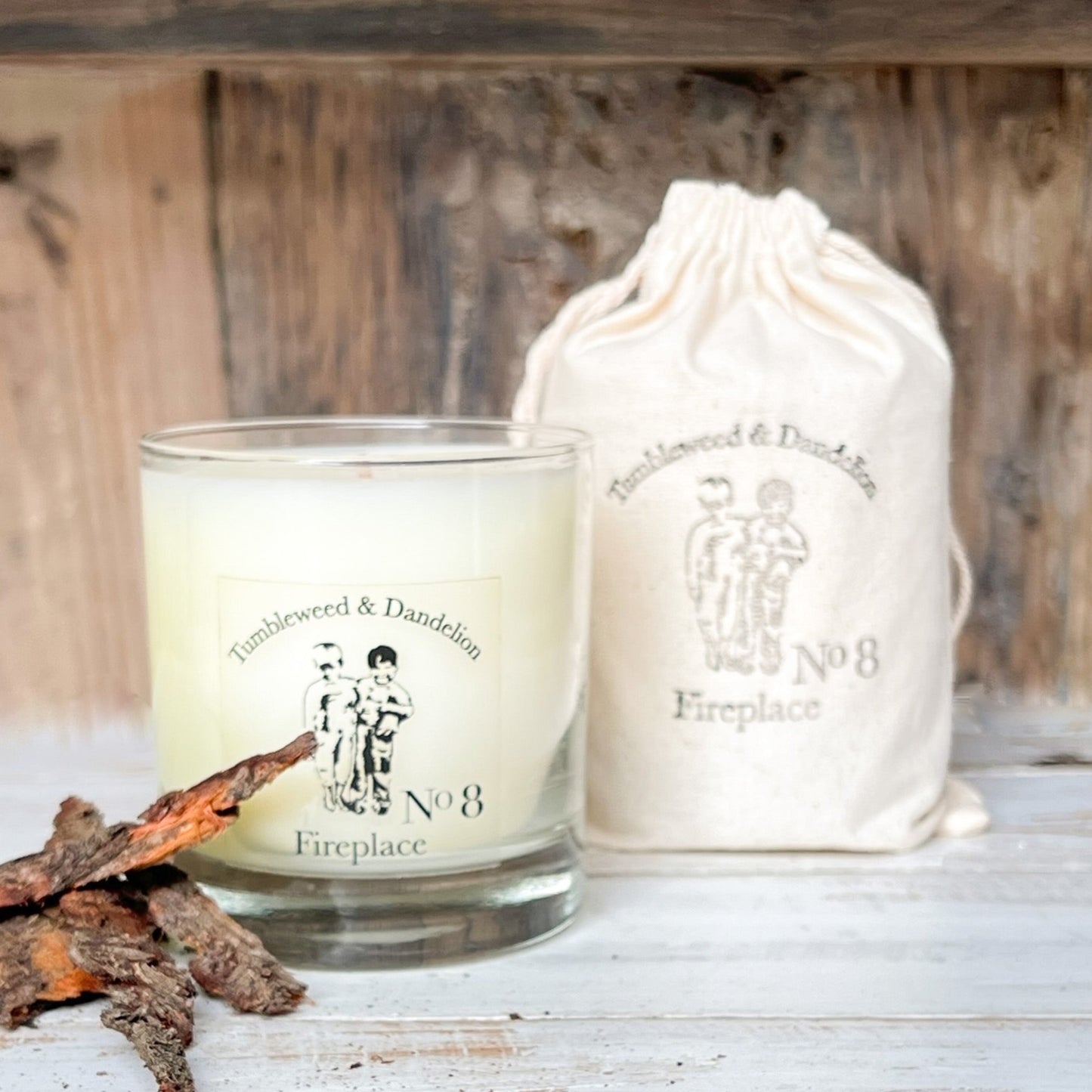 clear glass candle with black Tumbleweed logo, fireplace scent