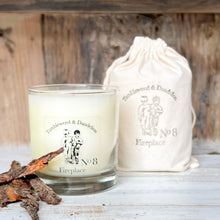 Load image into Gallery viewer, clear glass candle with black Tumbleweed logo, fireplace scent