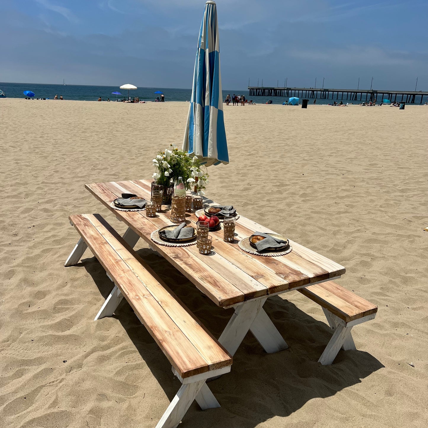 redwood picnic table and benches with natural tops and white bottoms
