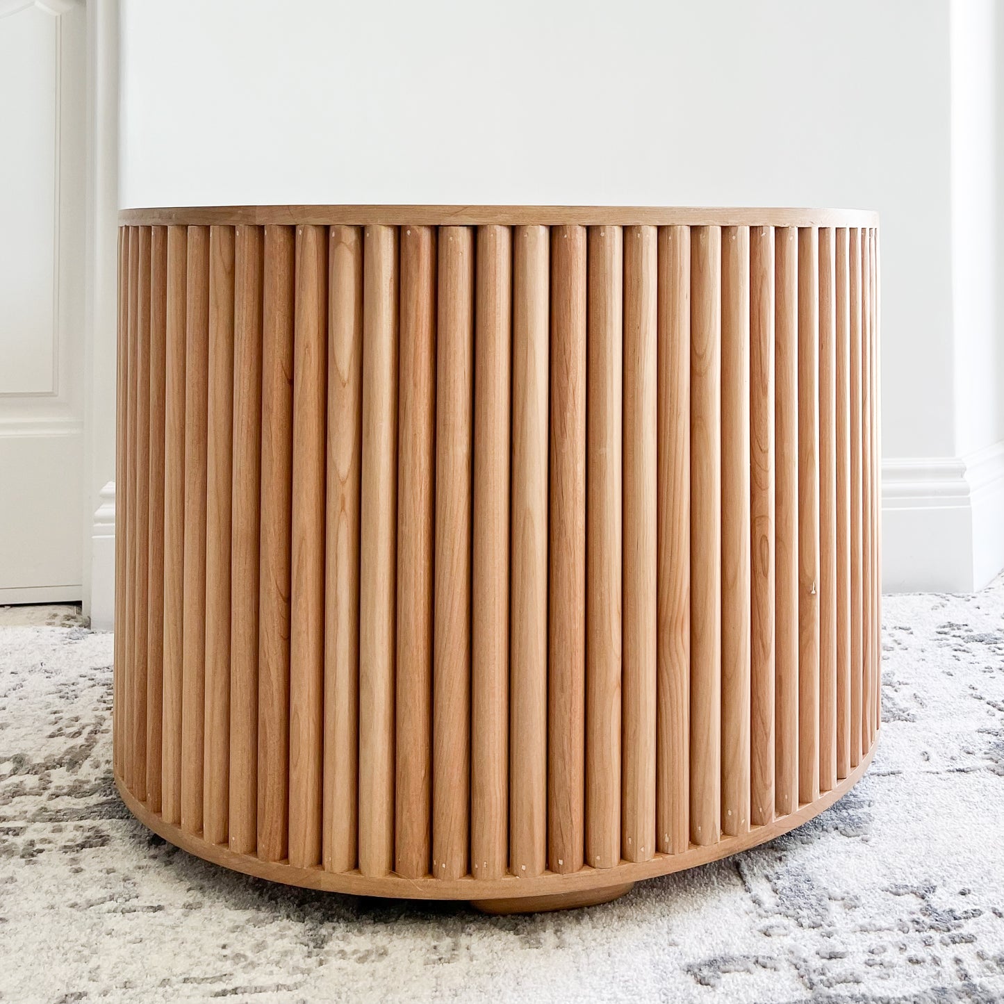 round side table with open middle and quarter round detailing on sides