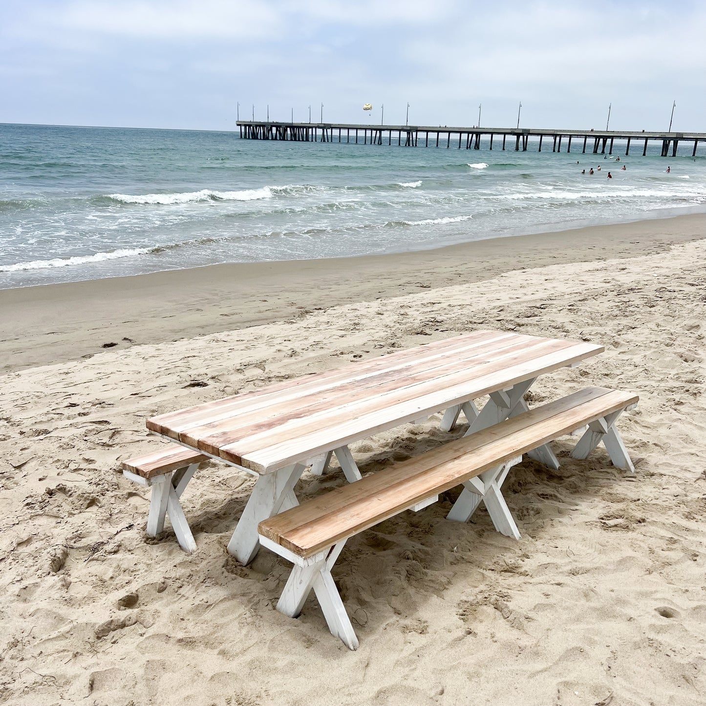redwood picnic table and benches with natural tops and white bottoms