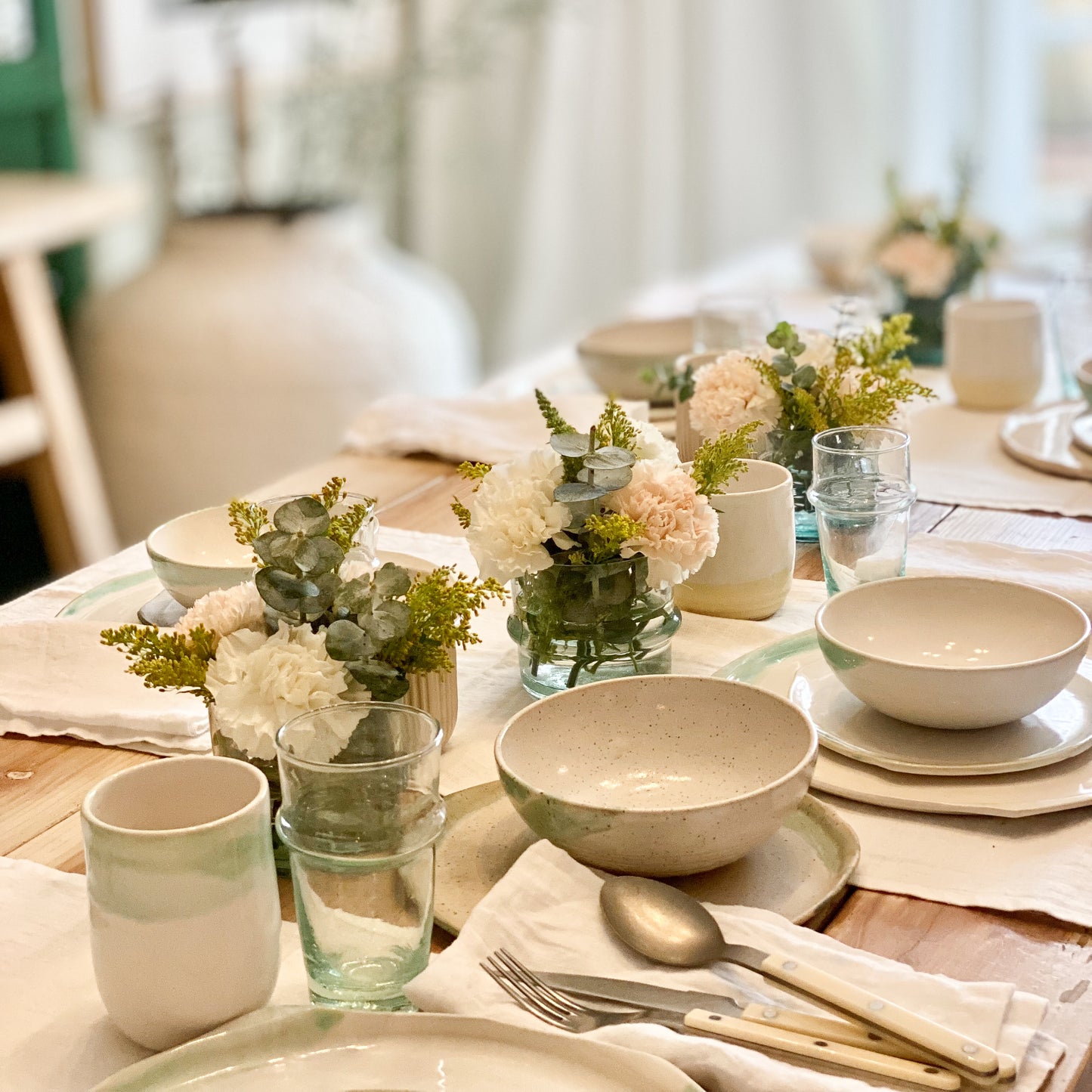 white ceramic plates and tumbler with green glazing