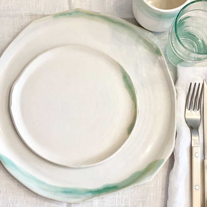 white ceramic plates with green glaze accents
