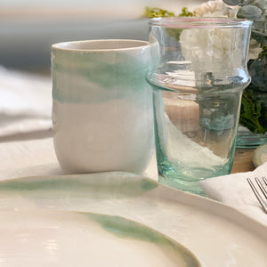 white ceramic dishes with brown speckles and green and brown glaze accents