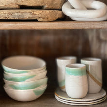 Load image into Gallery viewer, white ceramic bowls, tumblers and salad plates with green and brown glaze