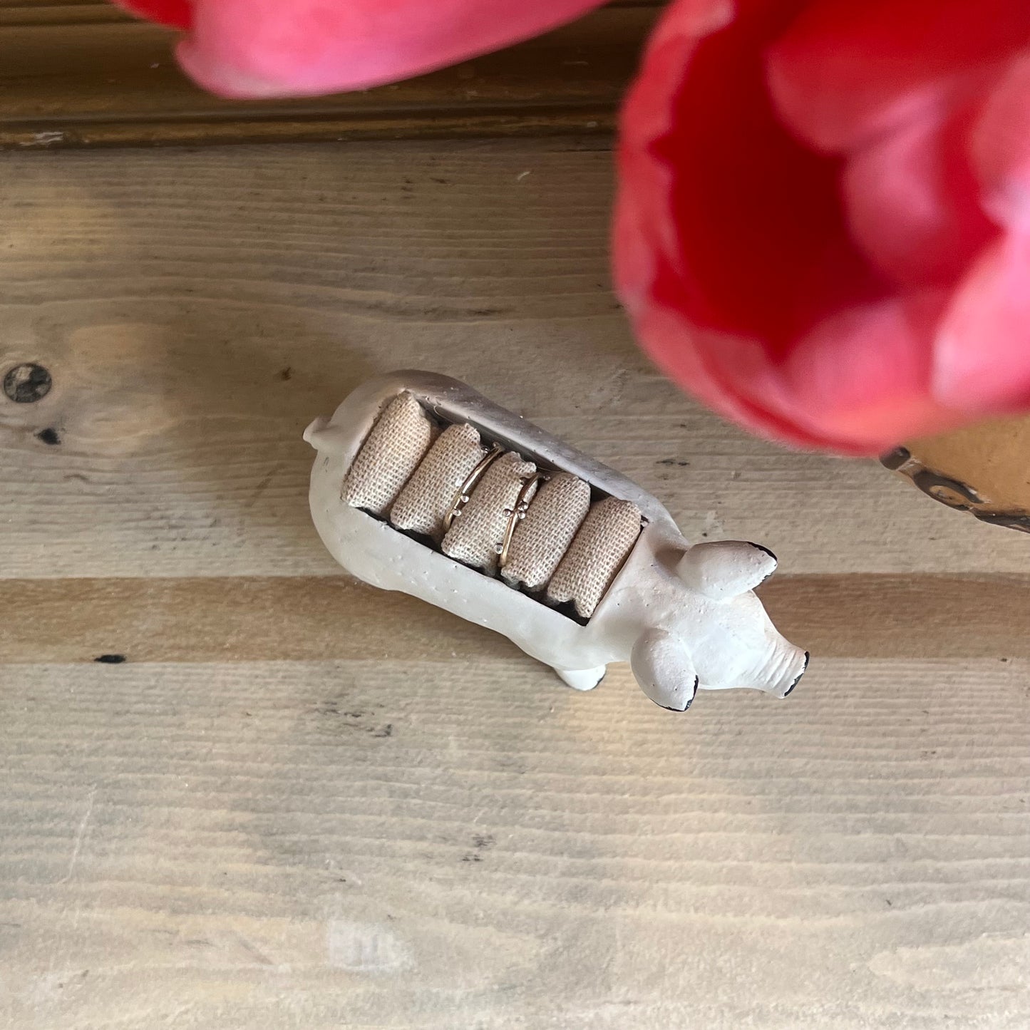 white metal pig ring holder, with burlap slots on top for rings