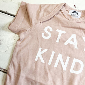 light pink baby onesie with STAY KIND in white on front
