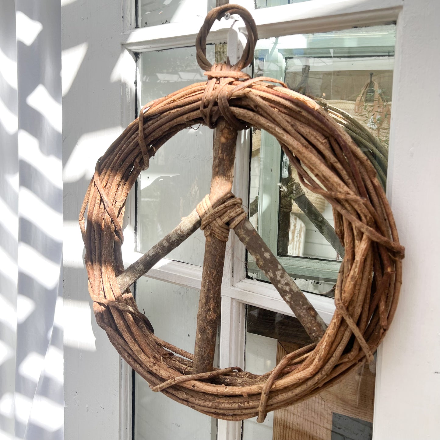 brown vine twig wreath in shape of a peace sign