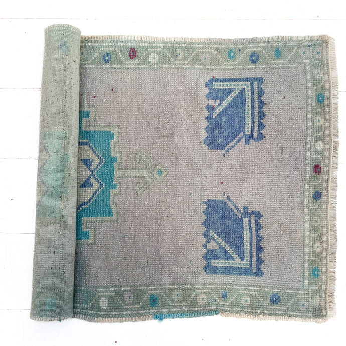vintage Turkish area rug with gray. blue and green colors