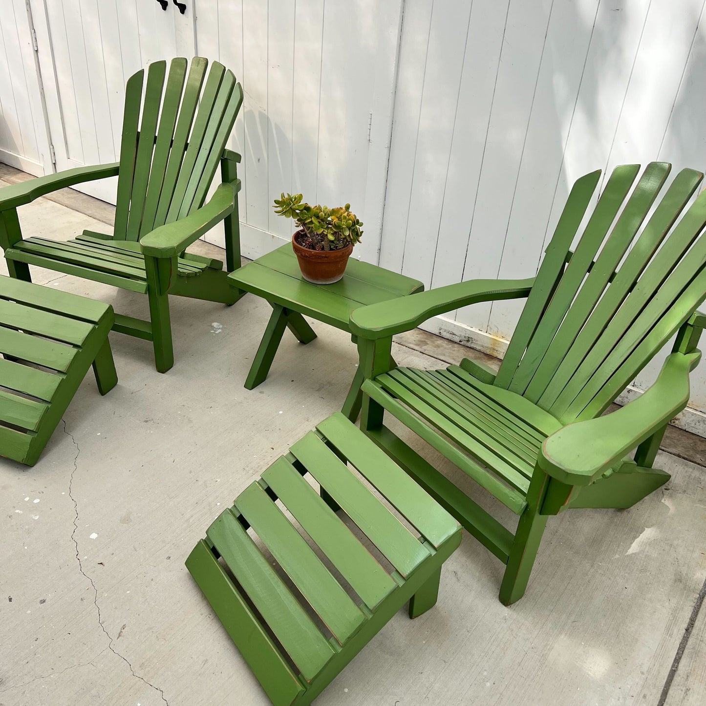 grass green painted Adirondack chairs and ottomans