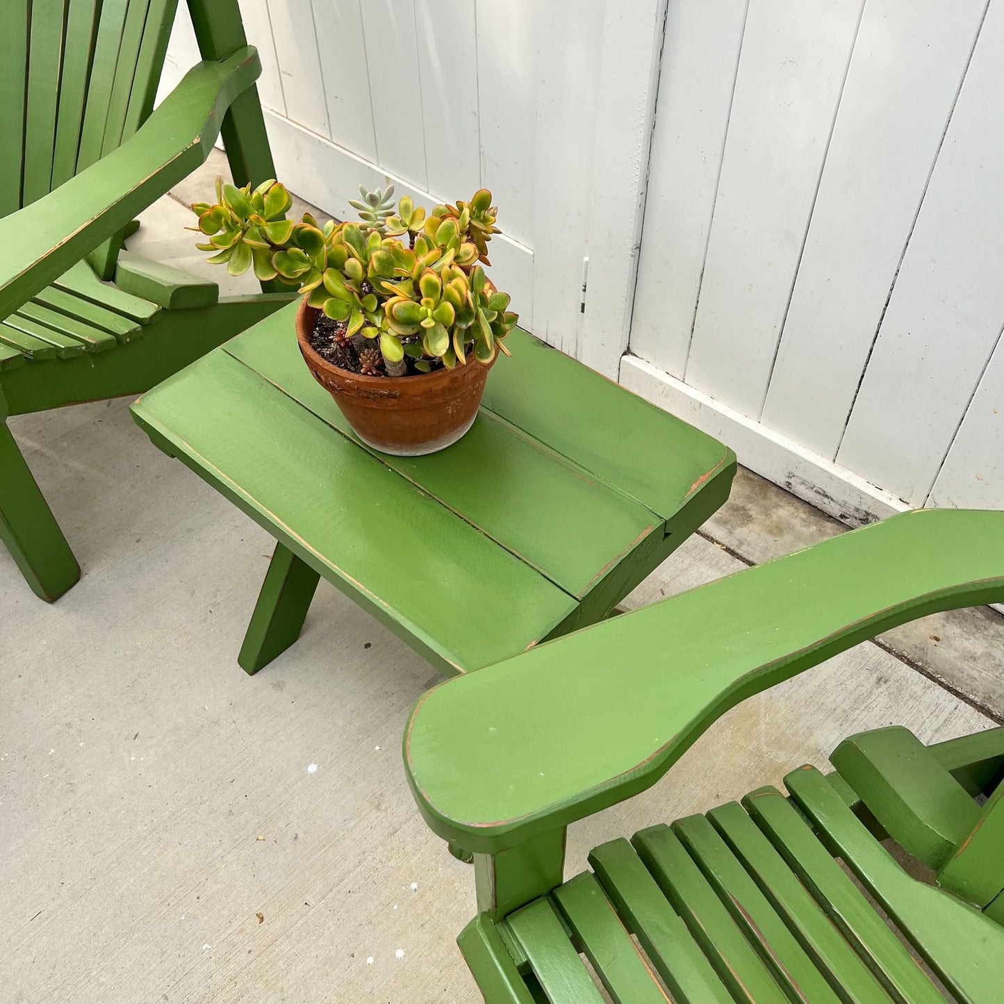 grass green painted Adirondack chairs and ottomans