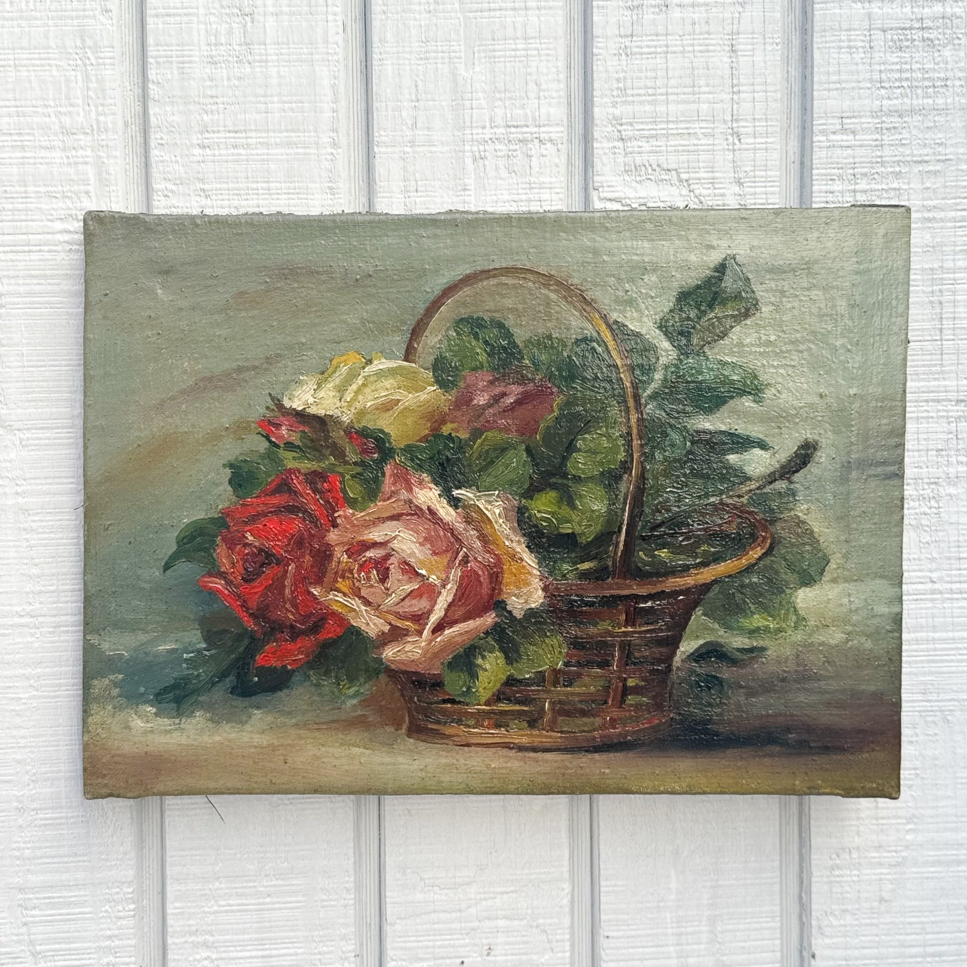 still life oil painting of a brown basket with different colored roses