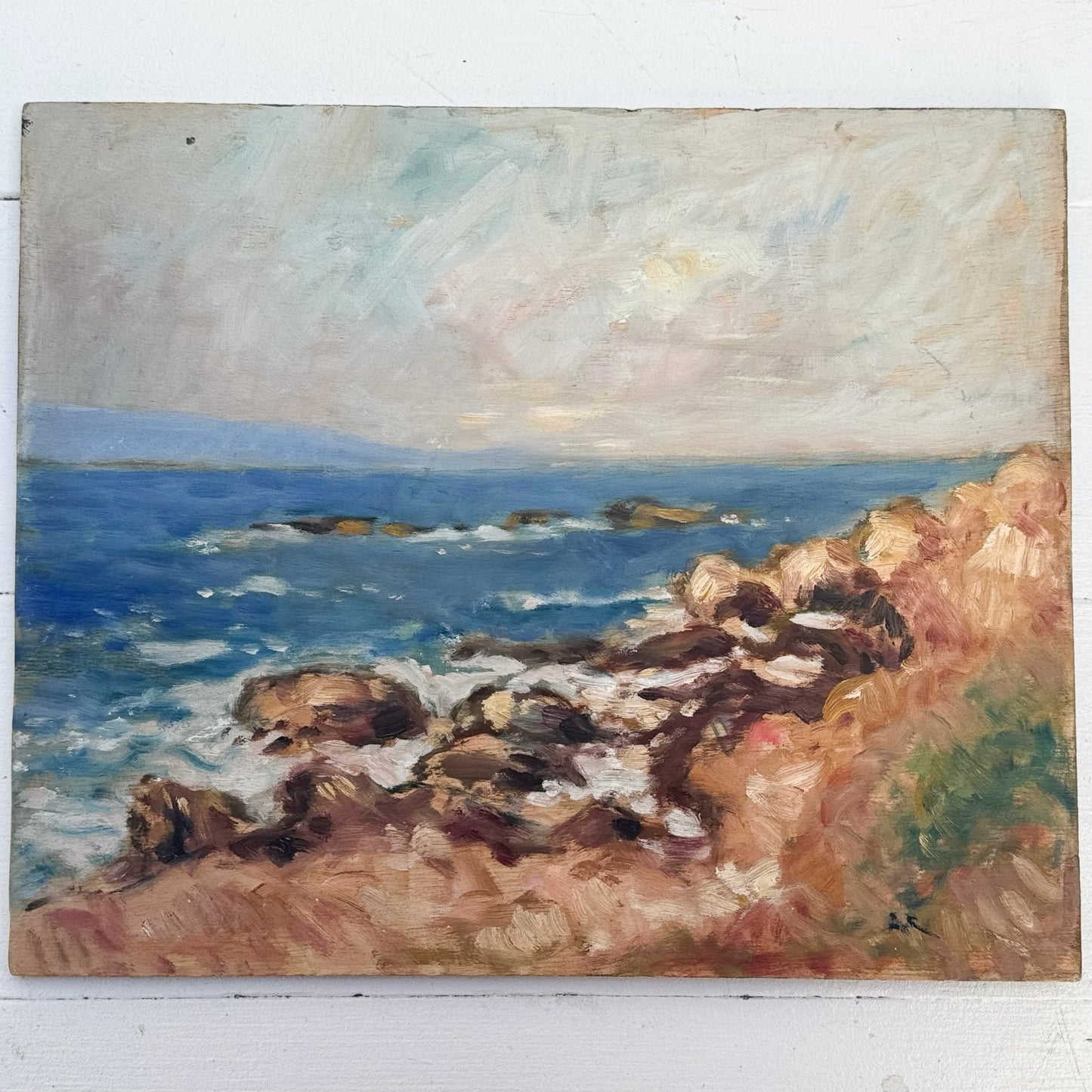 oil painting of a rocky seashore and cloudy sky