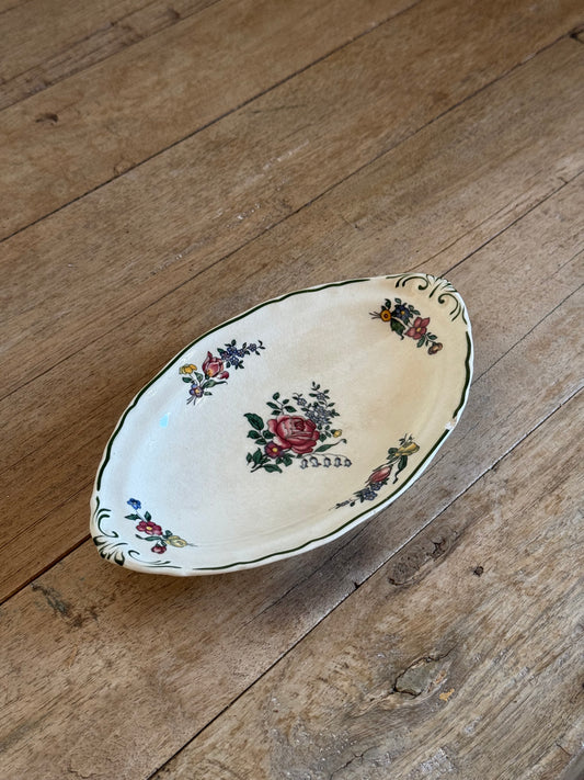 Decorative ceramic plate with floral patterns on a wooden surface