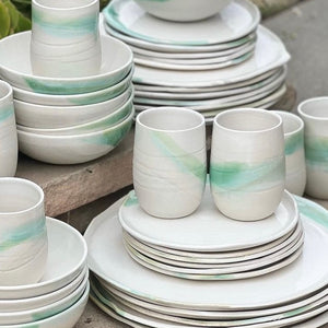 white ceramic plates with green glaze accents