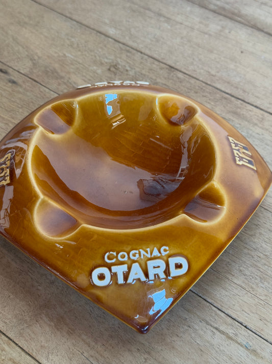 Cognac Otard catch all on a wooden surface