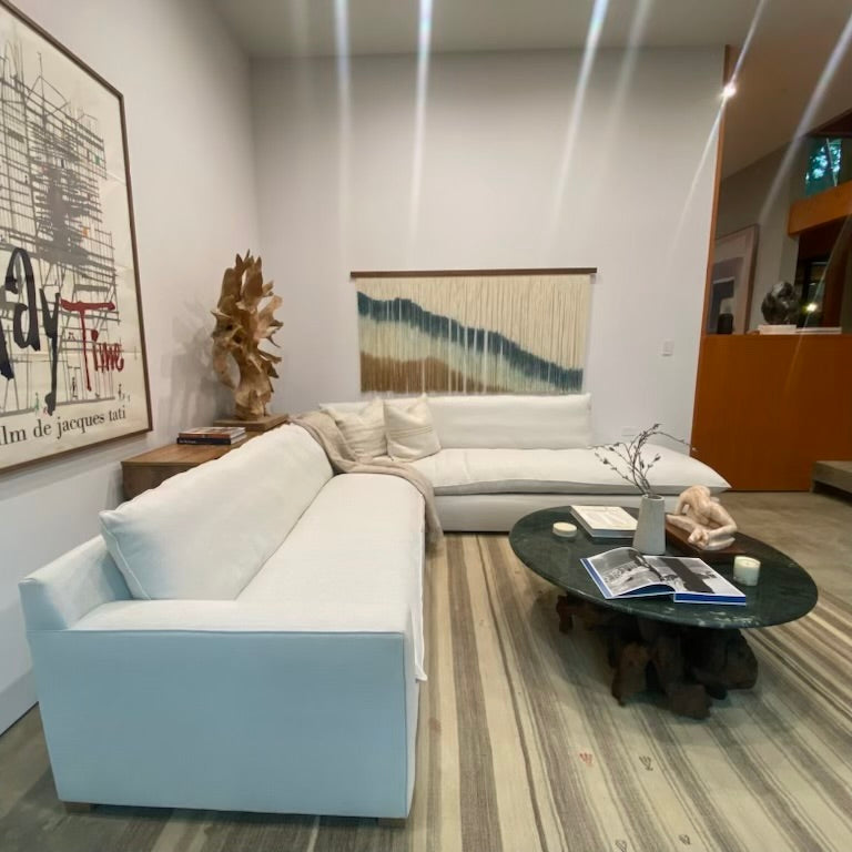 white 2 piece sectional sofa, with one part chaise, one part with left facing arm