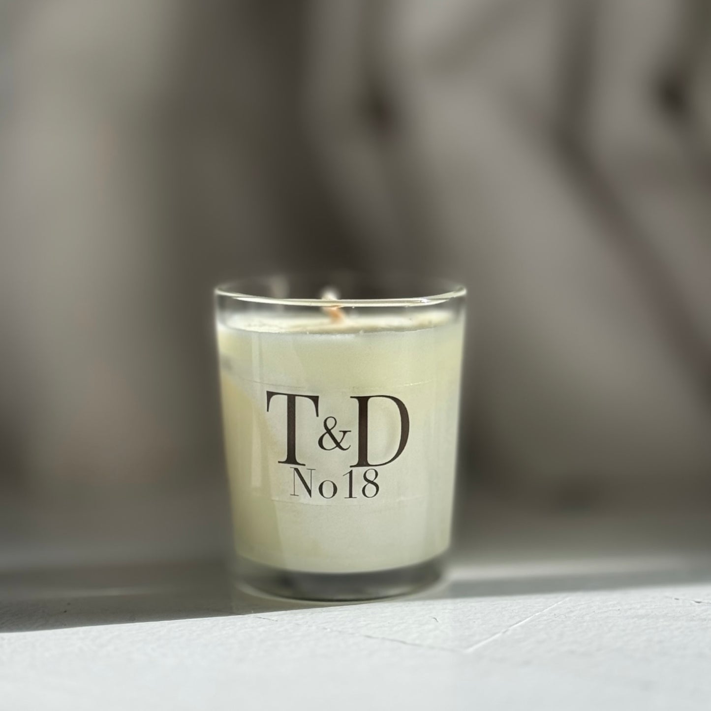 clear glass votive with clear label logo