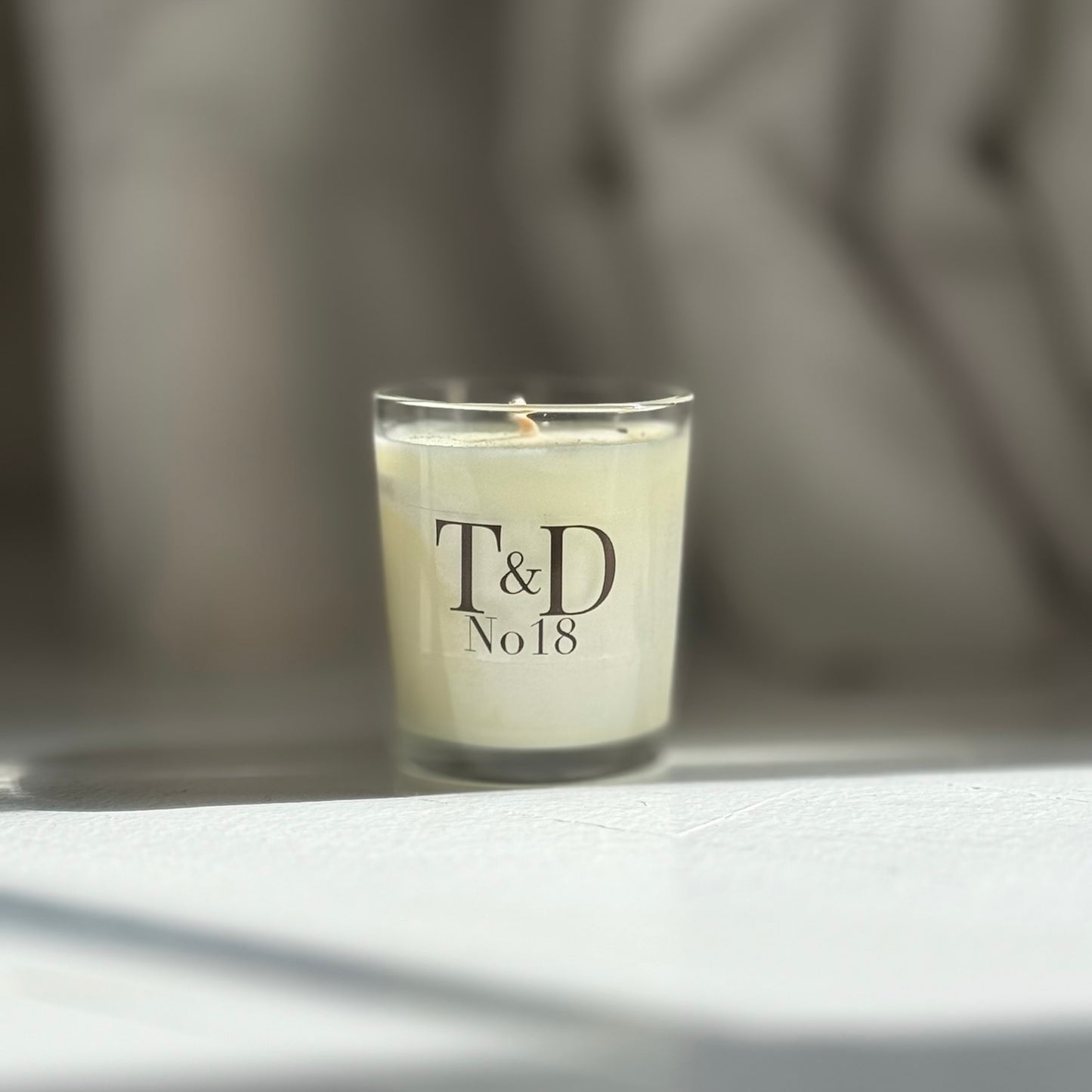 clear glass votive candle with logo
