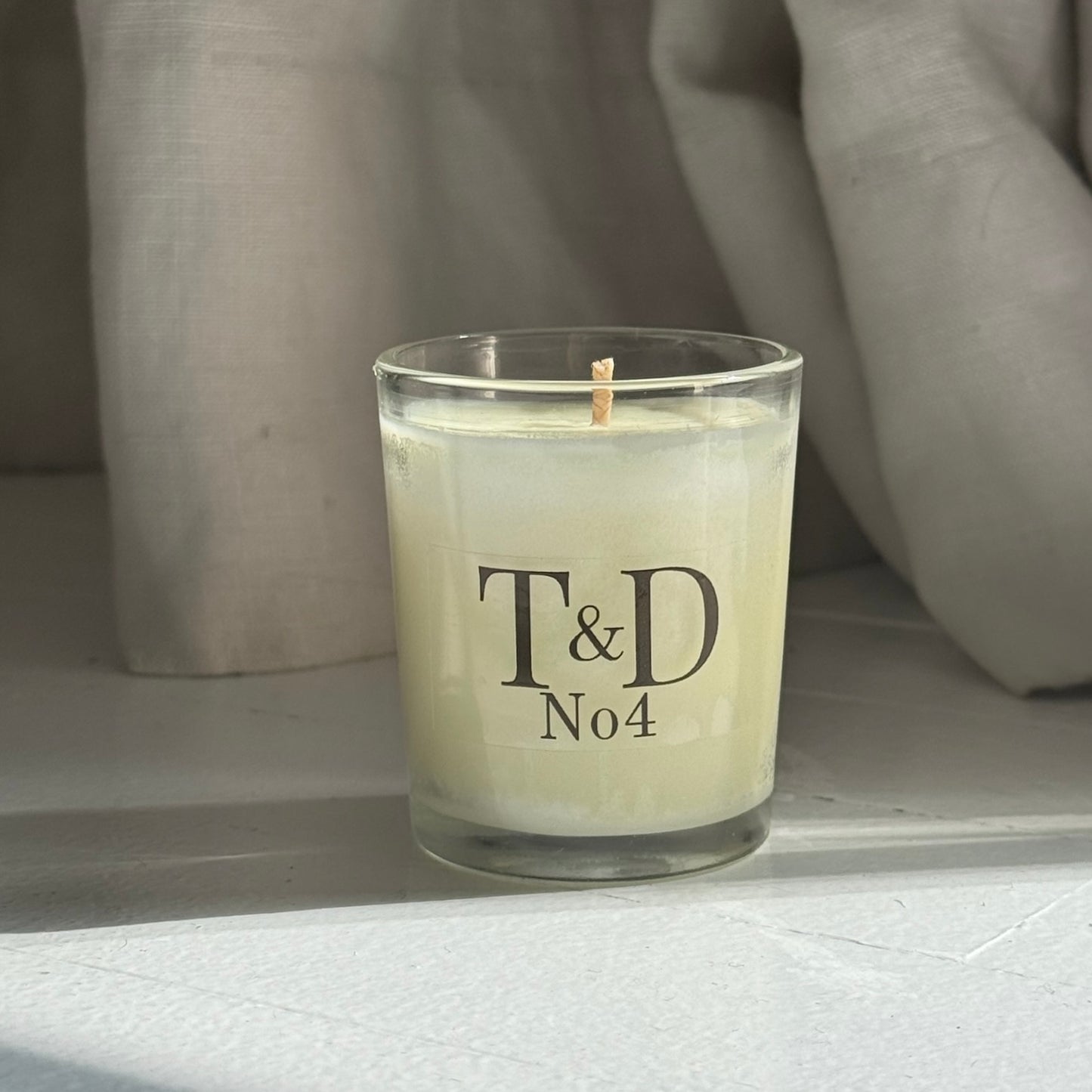 clear glass votive with clear label logo
